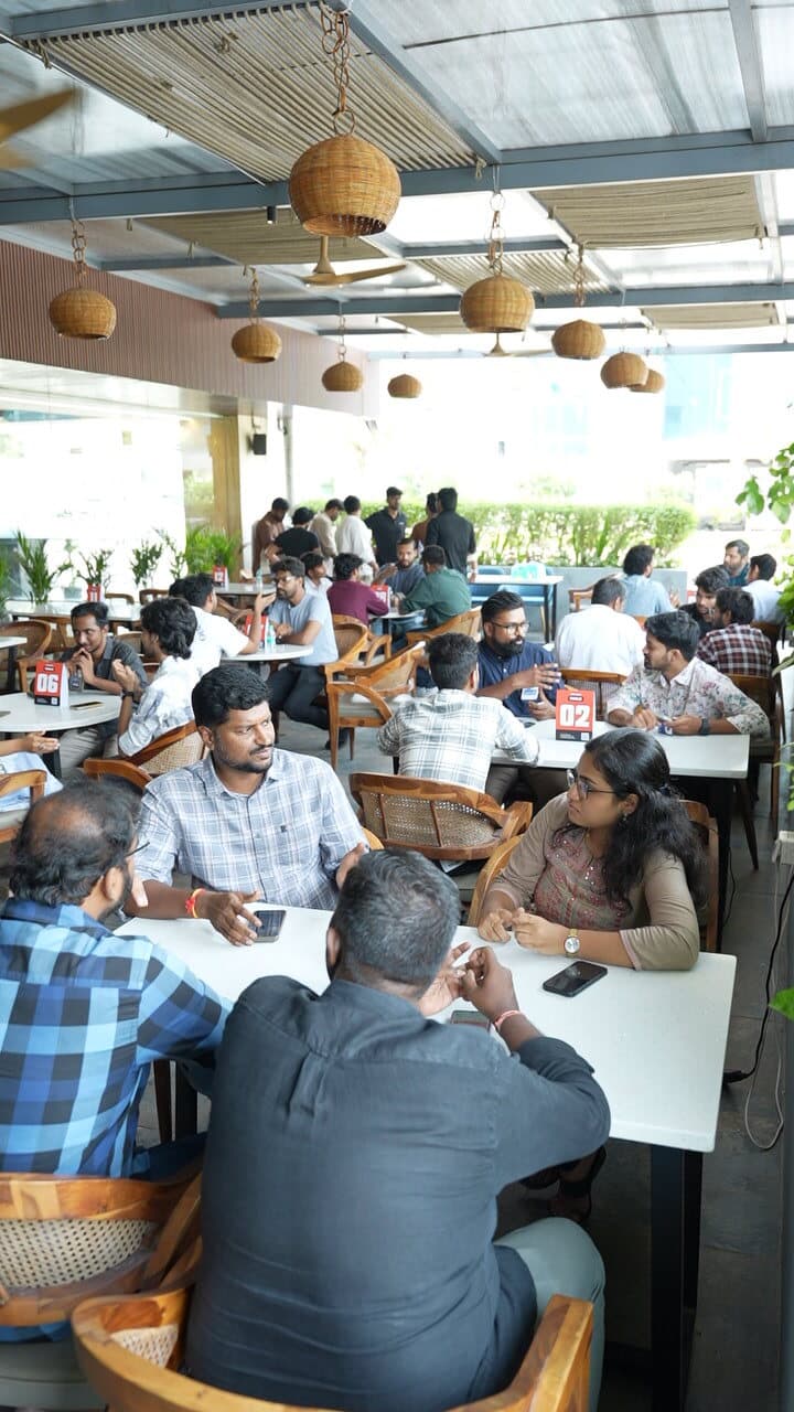 Founders talking around tables at a cafe